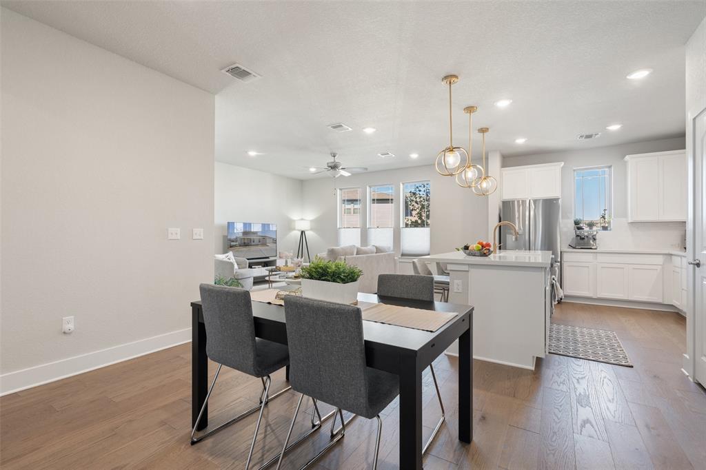 8419 Laughlin Lane Austin, TX 78744 - Photo 15 of 40 Dining room with dark wood-style floors, recessed lighting, a ceiling fan.