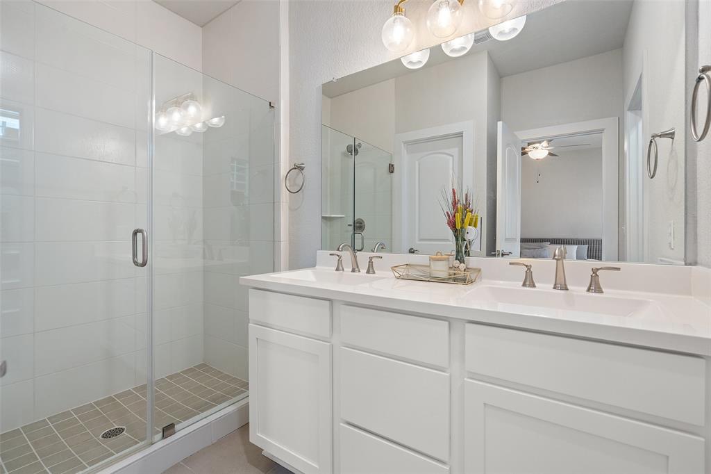 8419 Laughlin Lane Austin, TX 78744 - Photo 22 of 40 Ensuite bathroom featuring double vanity, a stall shower.