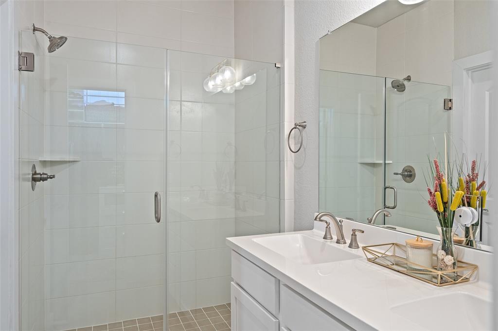 8419 Laughlin Lane Austin, TX 78744 - Photo 23 of 40 Bathroom with double vanity and a shower stall