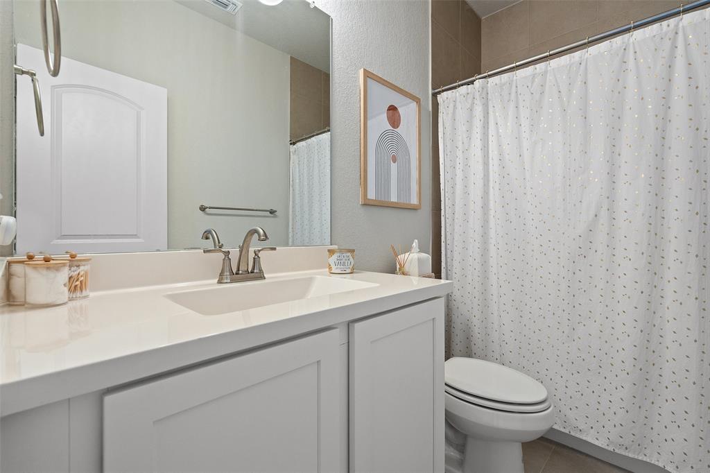 8419 Laughlin Lane Austin, TX 78744 - Photo 28 of 40 Bathroom with a vanity and tile patterned flooring