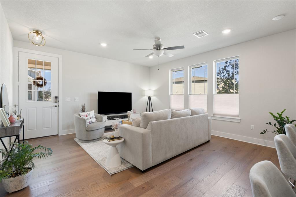 8419 Laughlin Lane Austin, TX 78744 - Photo 6 of 40 Living room with hardwood / wood-style floors, recessed lighting, and ceiling fan