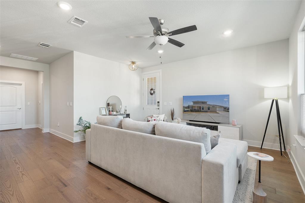 8419 Laughlin Lane Austin, TX 78744 - Photo 8 of 40 Living area featuring ceiling fan, wood finished floors, and recessed lighting