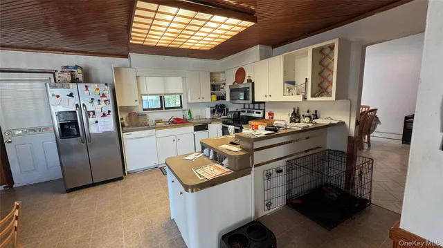 a kitchen with a sink appliances and cabinets