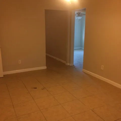 a view of an empty room with closet area