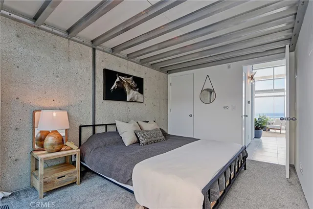 a bed room with a bed and a large window