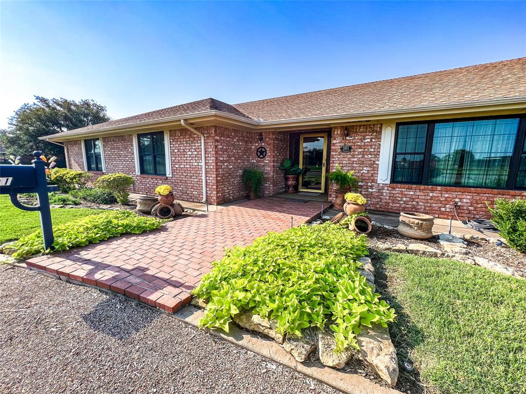 a front view of a house with yard and porch