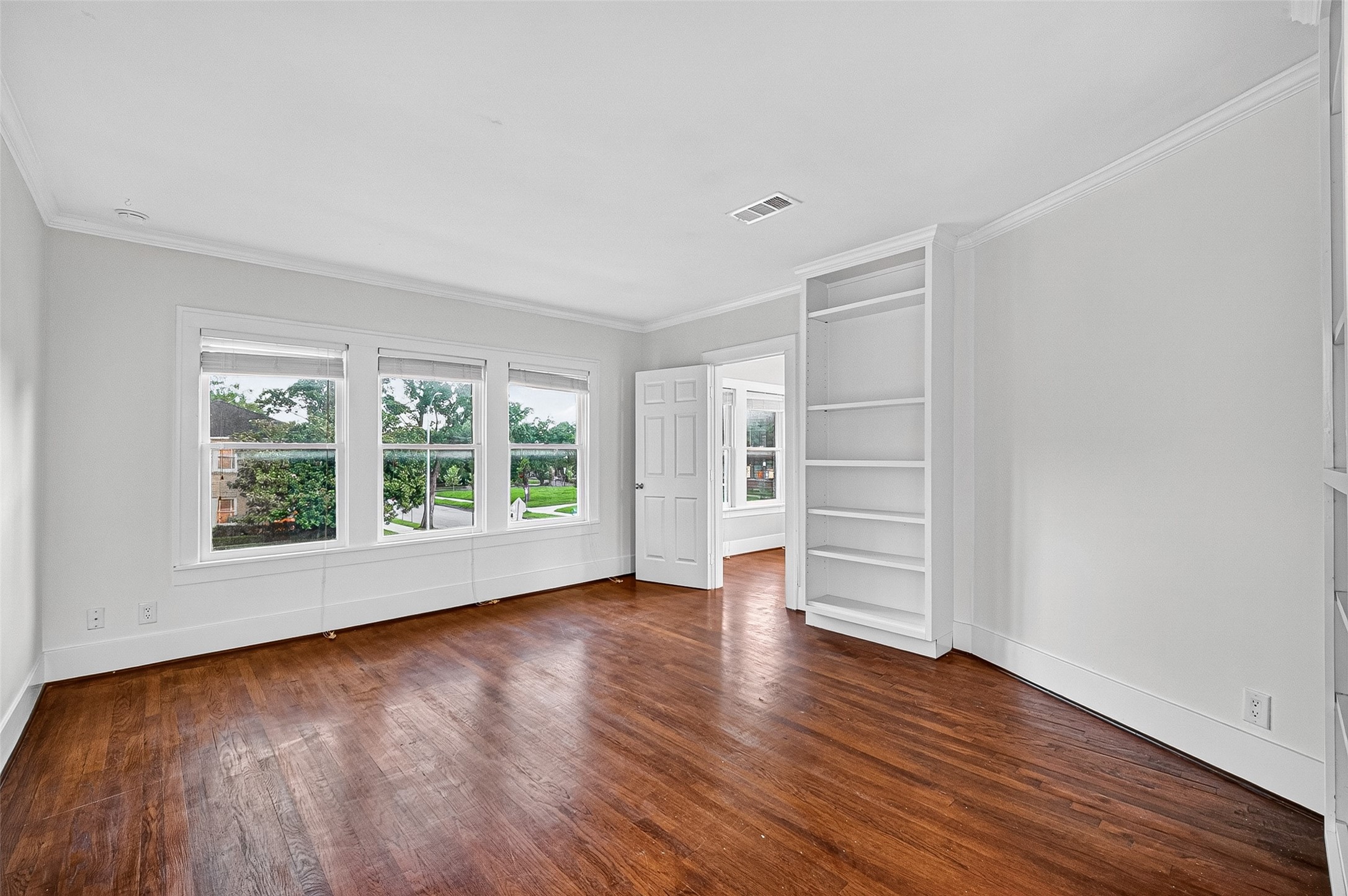 1758 Hawthorne Street, Unit 2 Houston, TX 77098 - Photo 5 of 19 Bright and spacious living room with large windows, hardwood floors, gray walls, and recessed lighting. Ideal for natural light and modern living.
