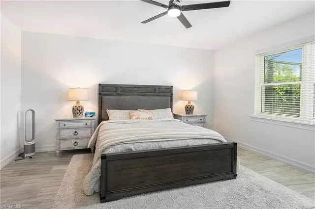 a bedroom with a bed and a night stand