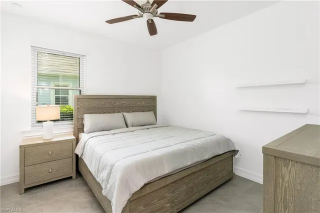 a bathroom with a granite countertop sink a toilet and bathtub