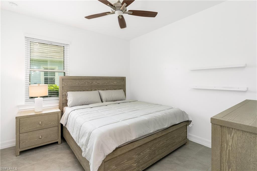 14837 Windward Lane Naples, FL 34114 - Photo 19 of 39 a bedroom with a bed and a window