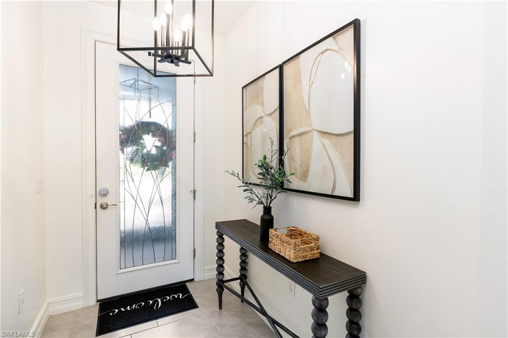 14837 Windward Lane Naples, FL 34114 - Photo 2 of 39 a view of entryway with wooden floor