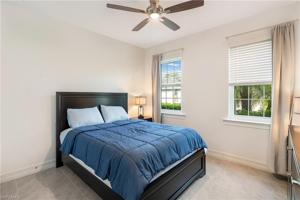 14837 Windward Lane Naples, FL 34114 - Photo 21 of 39 a bedroom with a bed and window