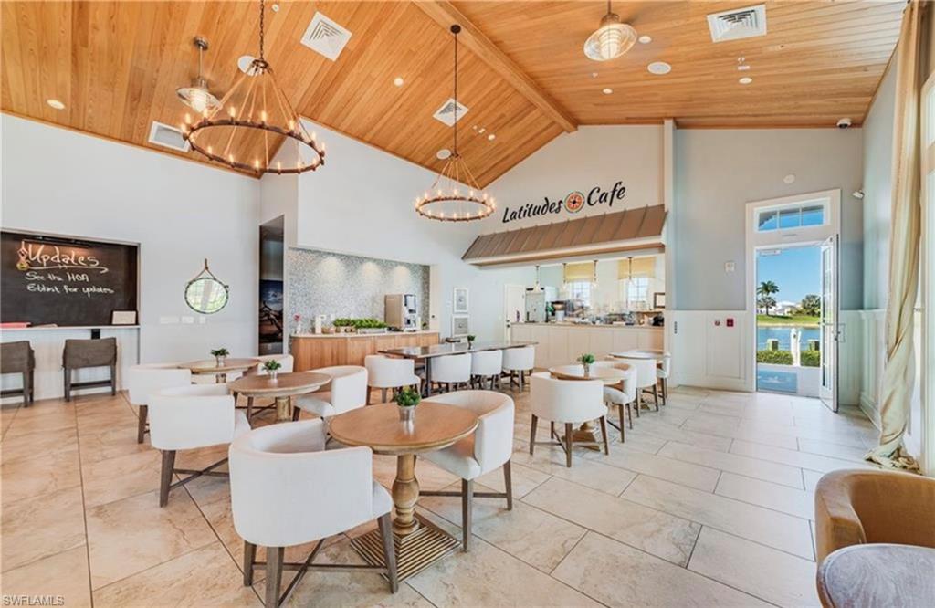 14837 Windward Lane Naples, FL 34114 - Photo 26 of 39 a room with lots of tables a large window and chairs