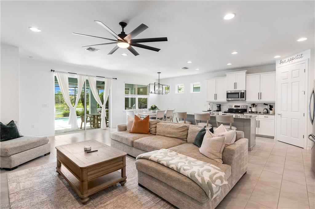 14837 Windward Lane Naples, FL 34114 - Photo 3 of 39 a living room with furniture and a large window