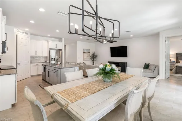 a living room with stainless steel appliances kitchen island granite countertop furniture and a view of kitchen