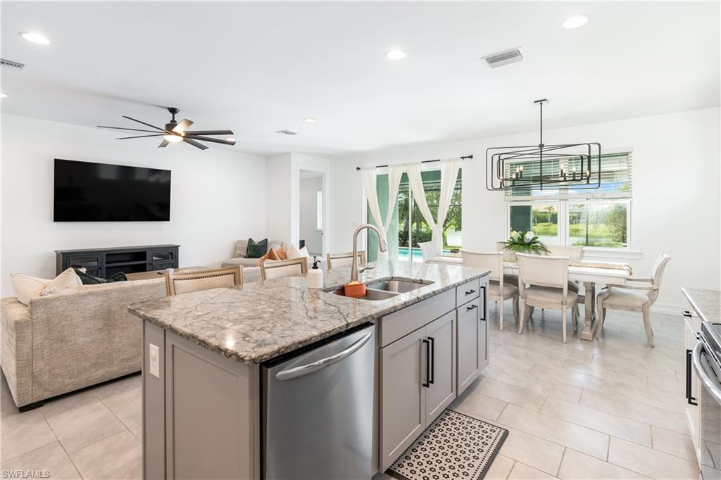 14837 Windward Lane Naples, FL 34114 - Photo 7 of 39 a kitchen with a stove a sink and a refrigerator