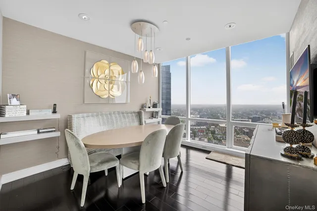 a dining room with furniture a chandelier and wooden floor