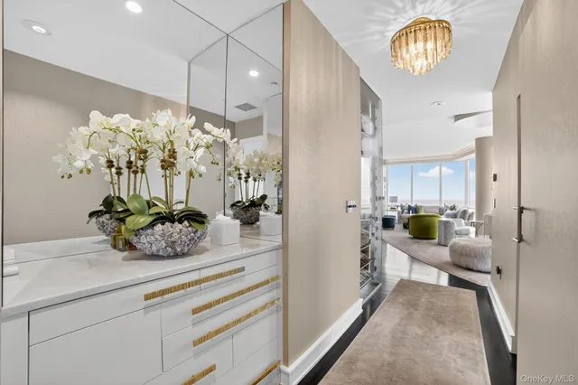 a living room with furniture and a chandelier