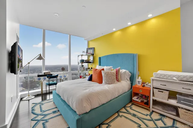 a bedroom with a bed a table and chair