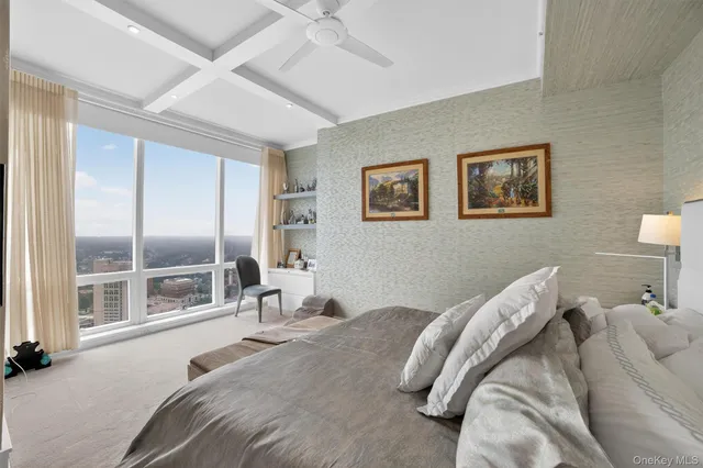 a bed room with a bed and a painting on the wall