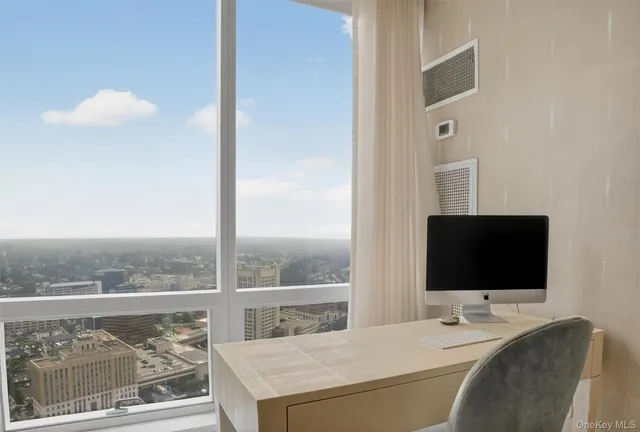 a living room with a flat screen tv and a floor to ceiling window
