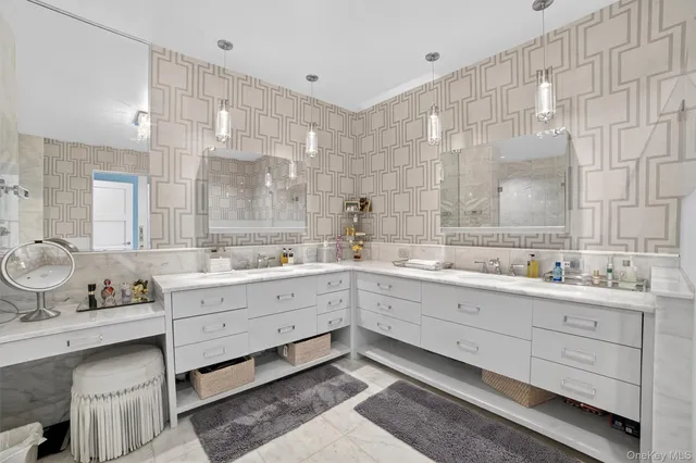 a bathroom with a double vanity sink a mirror and a