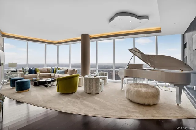 a living room with furniture and a floor to ceiling window