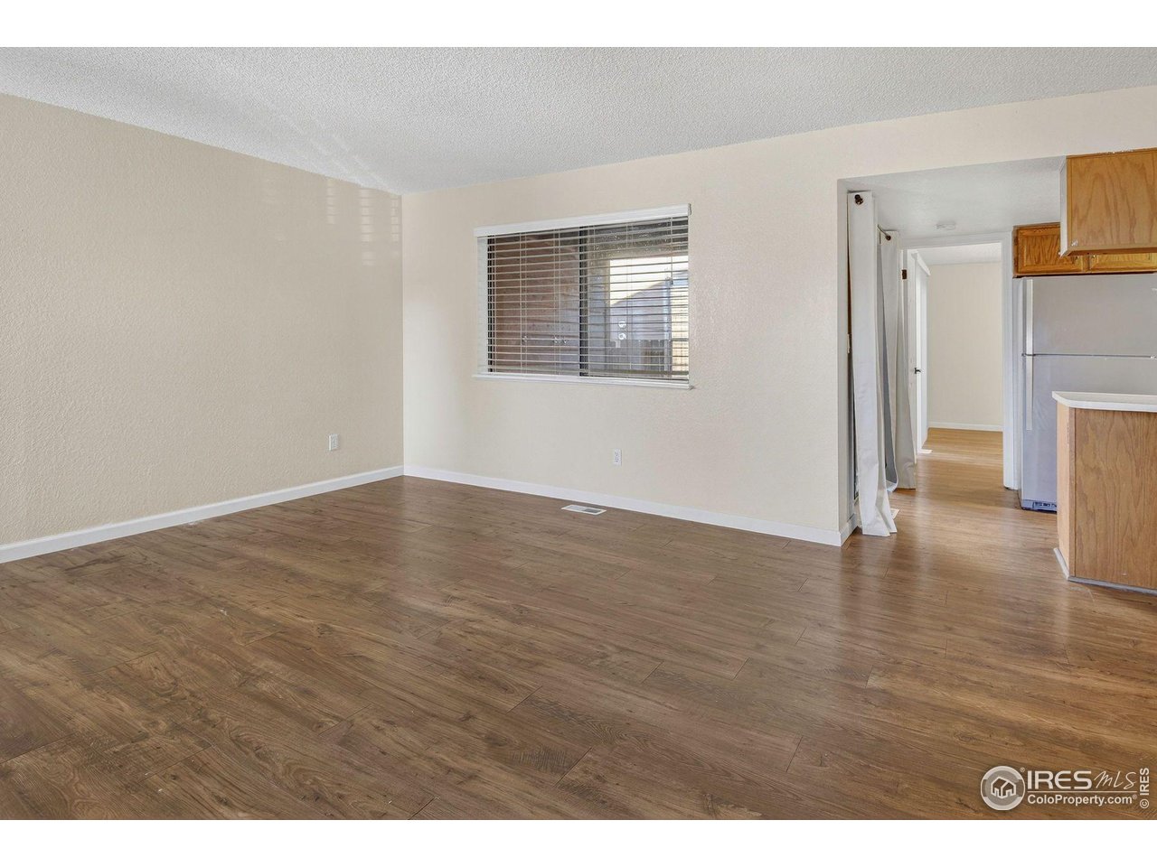 9407 West 89th Circle Broomfield, CO 80021 - Photo 12 of 32 a view of empty room with wooden floor