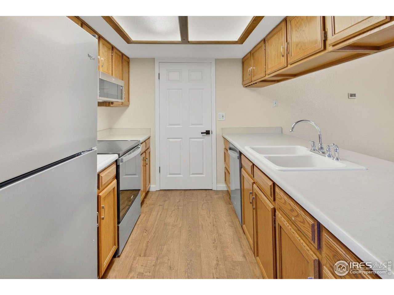 9407 West 89th Circle Broomfield, CO 80021 - Photo 14 of 32 a kitchen view with wooden floor
