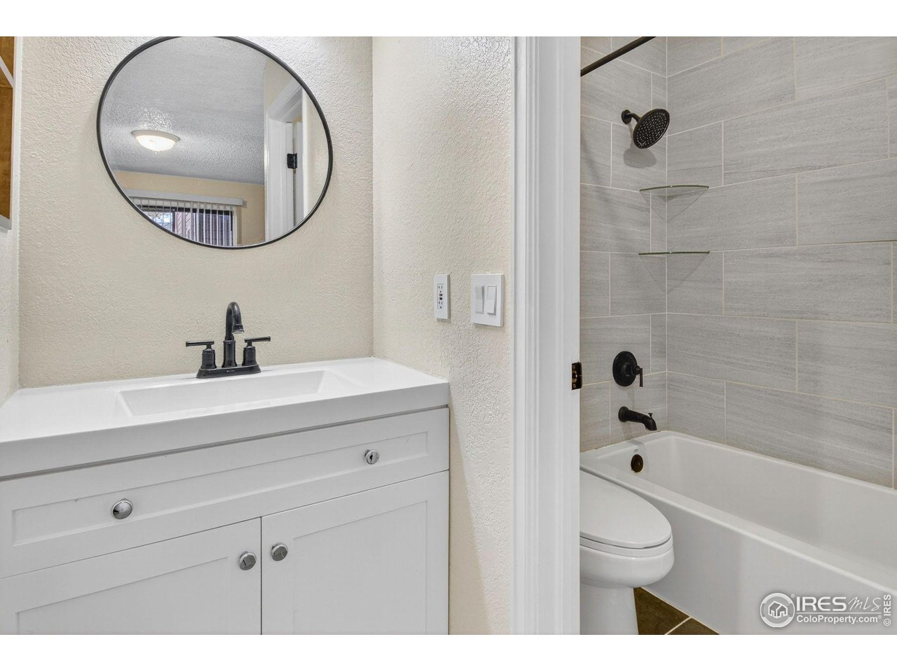 9407 West 89th Circle Broomfield, CO 80021 - Photo 20 of 32 a bathroom with a sink a toilet and a mirror