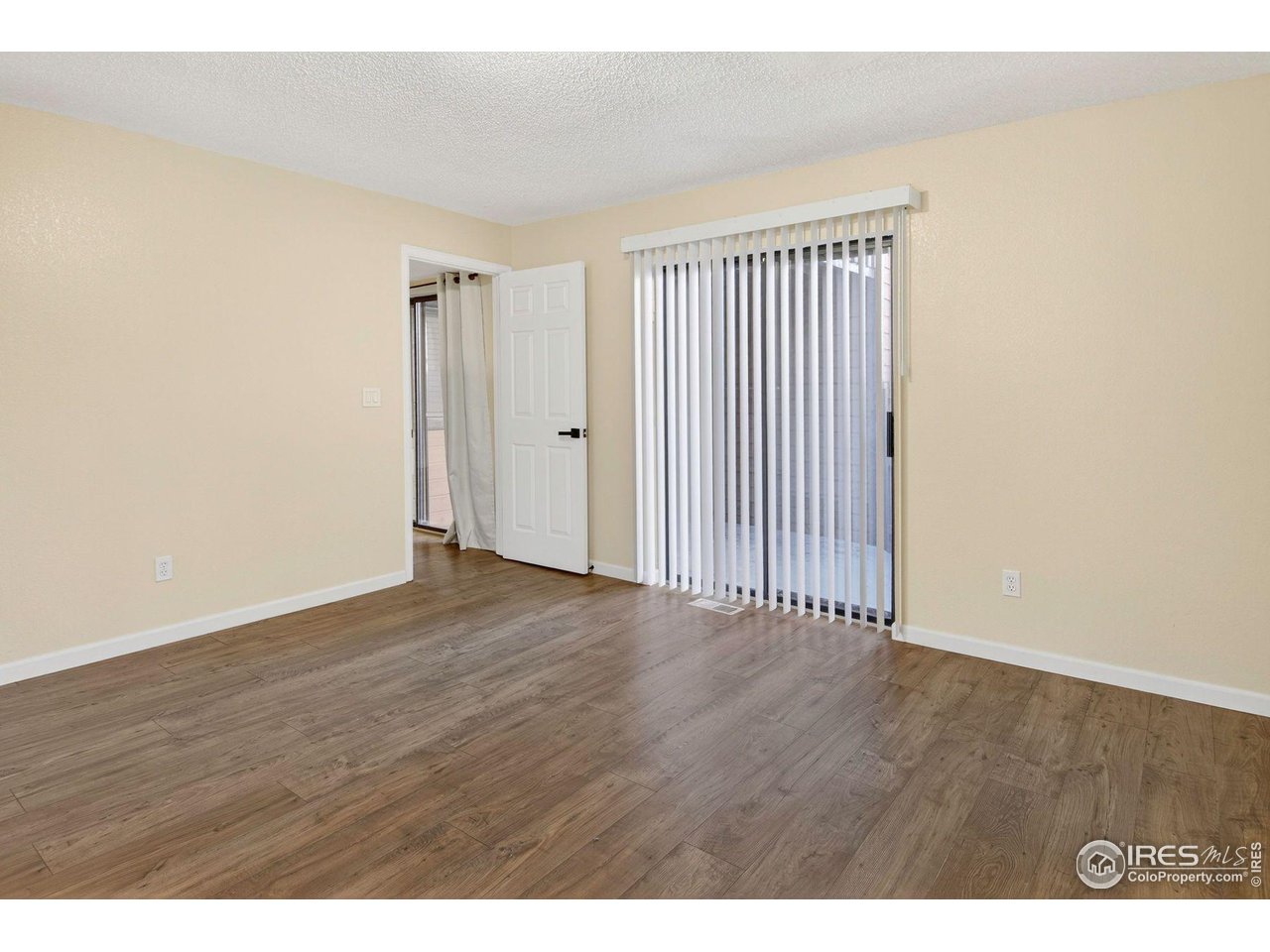 9407 West 89th Circle Broomfield, CO 80021 - Photo 6 of 32 a view of an empty room with wooden floor