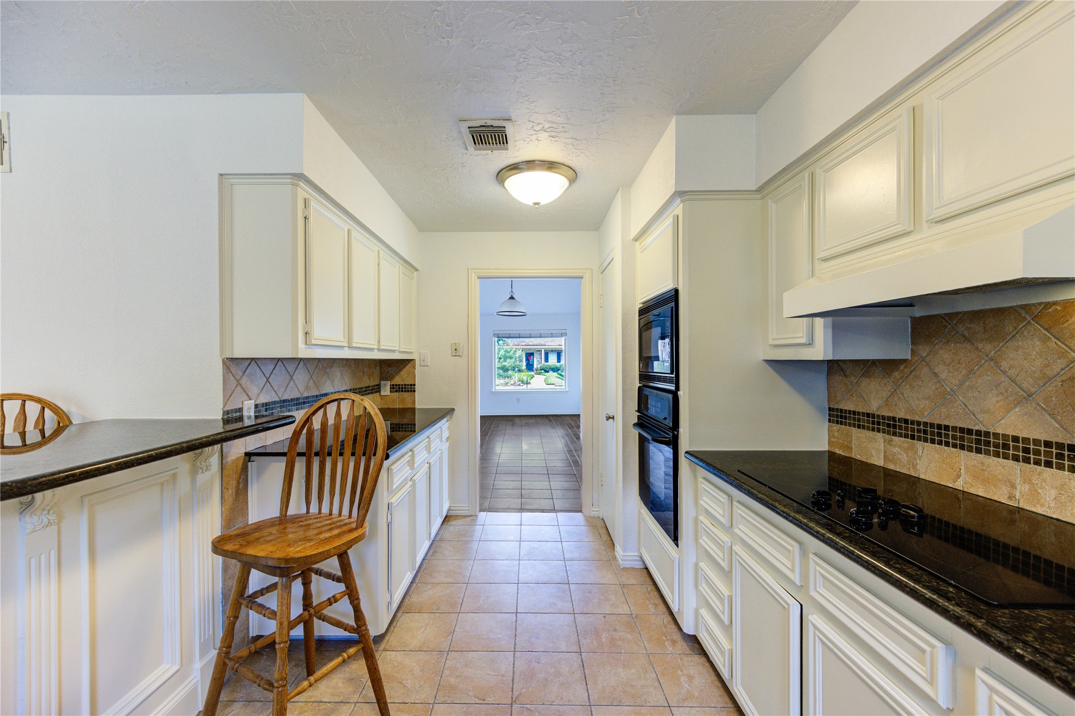 3639 Fir Forest Drive Spring, TX 77388 - Photo 18 of 44 a hallway with a dining table chairs and a stove