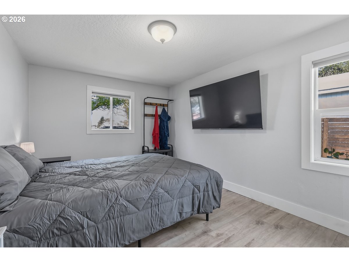 622 Southeast 111th Avenue Portland, OR 97216 - Photo 15 of 34 a bedroom with a bed and a flat screen tv