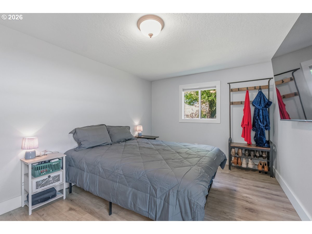 622 Southeast 111th Avenue Portland, OR 97216 - Photo 16 of 34 a bedroom with a bed and a view of kitchen