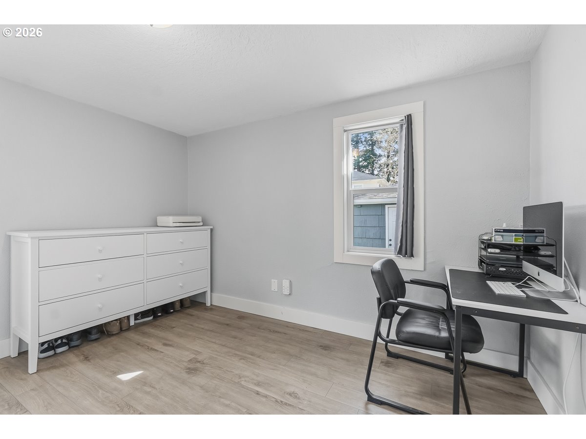 622 Southeast 111th Avenue Portland, OR 97216 - Photo 17 of 34 a bedroom with a bed and a chair