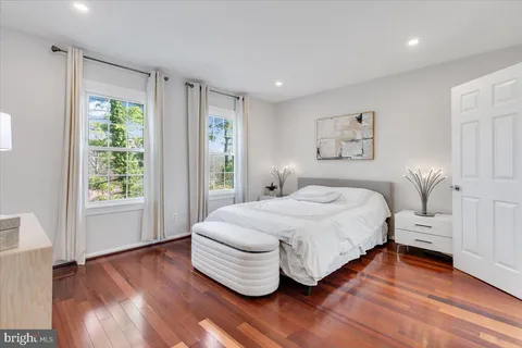 a bedroom with a bed and a large window