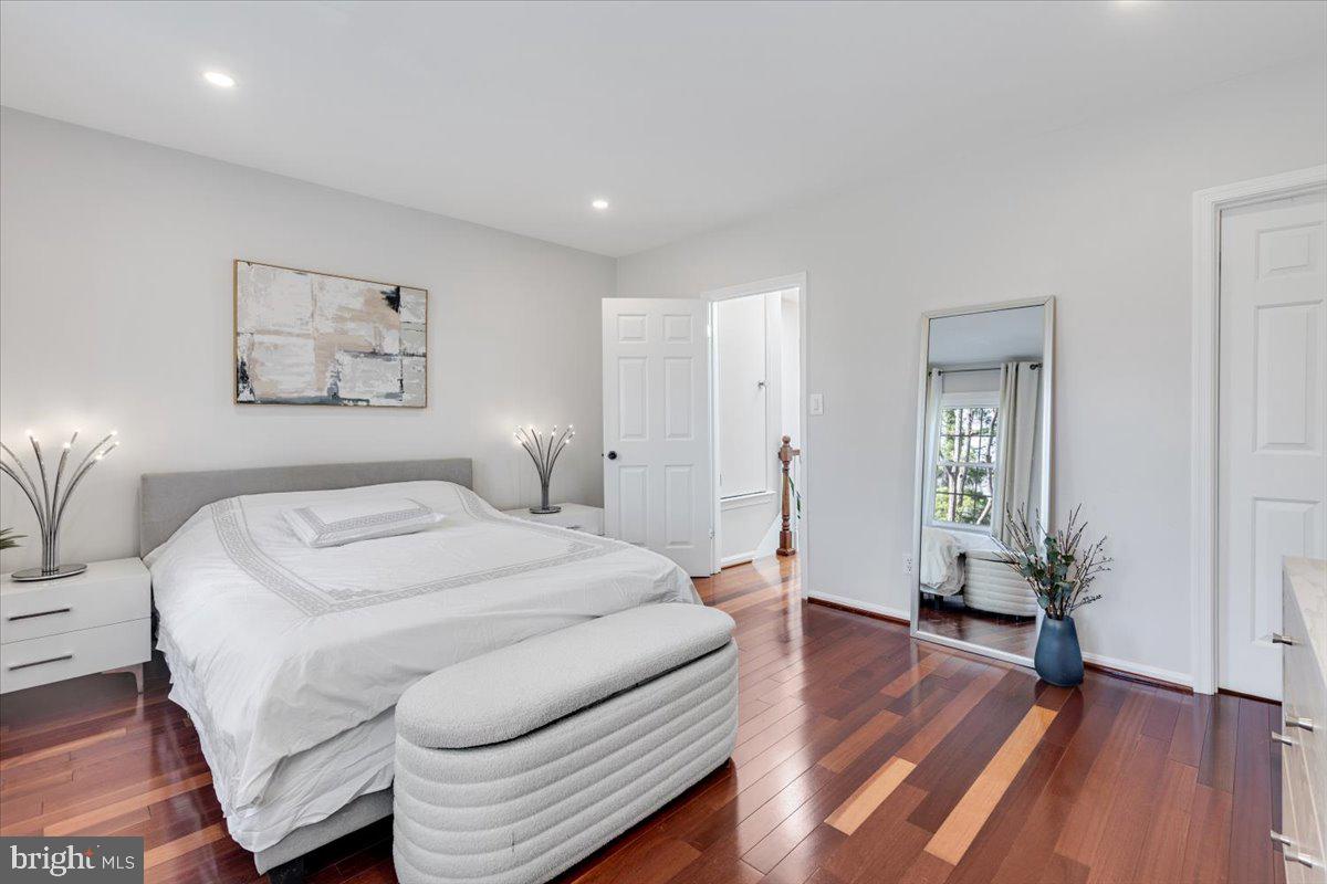 1949 Calvert Street Northwest, Unit E Washington, DC 20009 - Photo 14 of 29 a spacious bedroom with a bed and a wooden floor