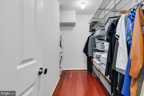 a view of walk in closet with clothes and shoes