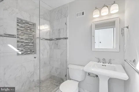 a bathroom with a sink toilet and shower