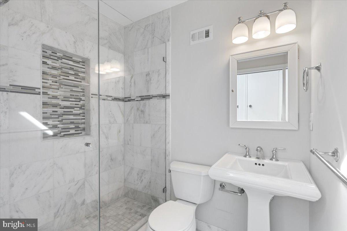 1949 Calvert Street Northwest, Unit E Washington, DC 20009 - Photo 20 of 29 a bathroom with a sink toilet and shower