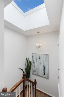 a view of a hallway with paintings on the wall