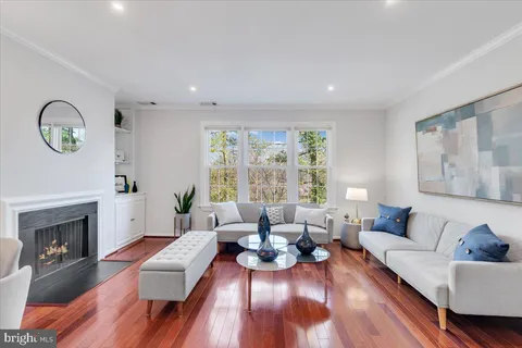 a living room with furniture wooden floor and a fireplace