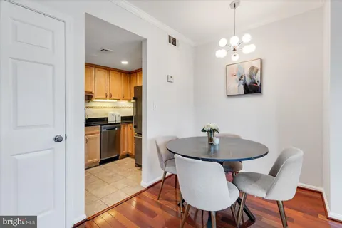a dining room with furniture and chandelier