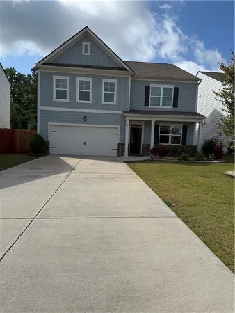 a front view of house with yard and green space