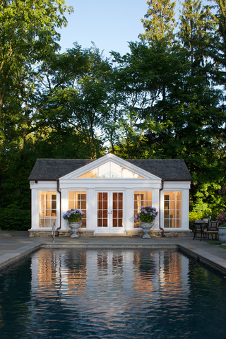 771 Washington Road Lake Forest, IL 60045 - Photo 4 of 25 a white house with a large pool and a large pool with lawn chairs under an umbrella