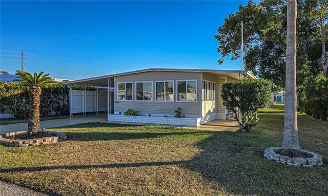 a view of a house with swimming pool and a yard