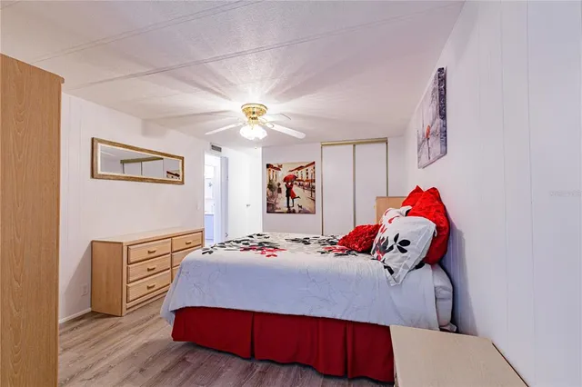 a bedroom with a bed and wooden floor