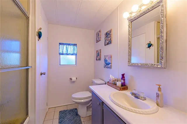 a bathroom with a sink and a mirror with toilet