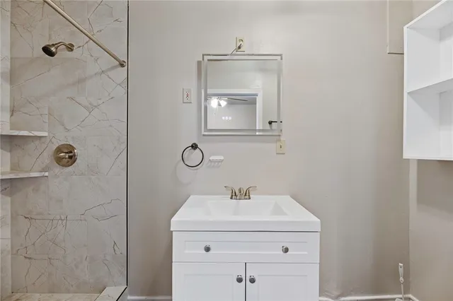 a bathroom with a sink a vanity and mirror