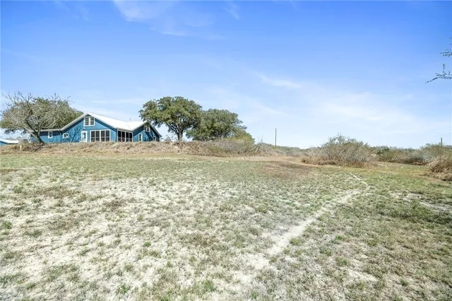 a view of ocean with green space